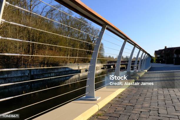 The Jubilee River Near Maidenhead And Taplow England On A Bright Afternoon In February With Its Curved Fence Running Alongside A Public Footpath Used By Pedestrians Stock Photo - Download Image Now