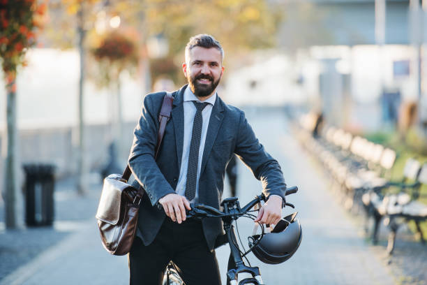 istock Businessman commuter with bicycle walking home from work in city. 1134616924