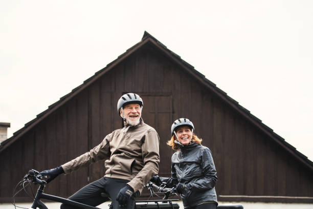 istock Active senior couple with electrobikes standing outdoors in front of a house. 1134620757