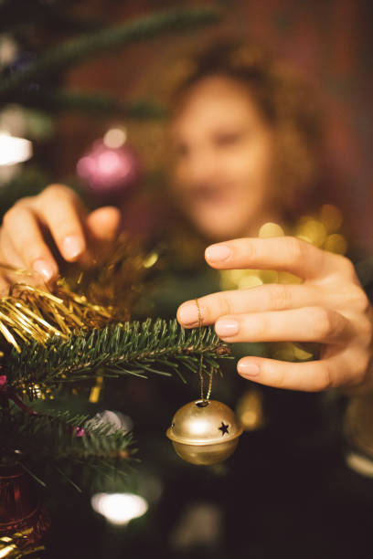 istock Woman Decorating Christmas Tree At Home 1134628355