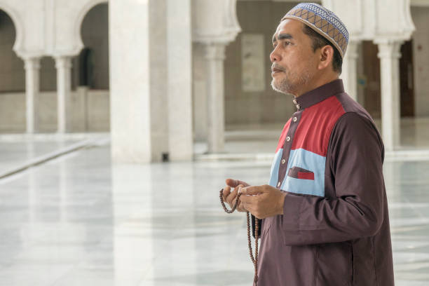 istock Side View Of Man With Necklace Standing In Mosque 1134628787