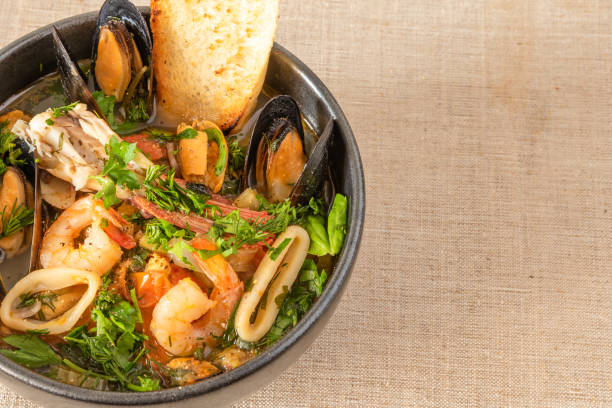 istock Traditional Mediterranean seafood stew in a black bowl, copy space, top view. 1134631352