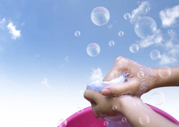 istock Cropped Hands Washing Cloth Against Sky 1134632262