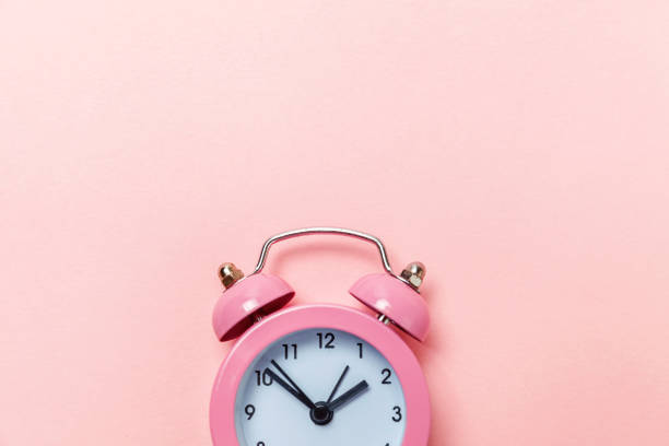 istock Vintage alarm clock Isolated on pink pastel background 1134635204