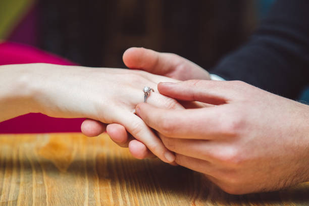 istock Young man puts wedding ring on girls hand. Close up. 1134635205