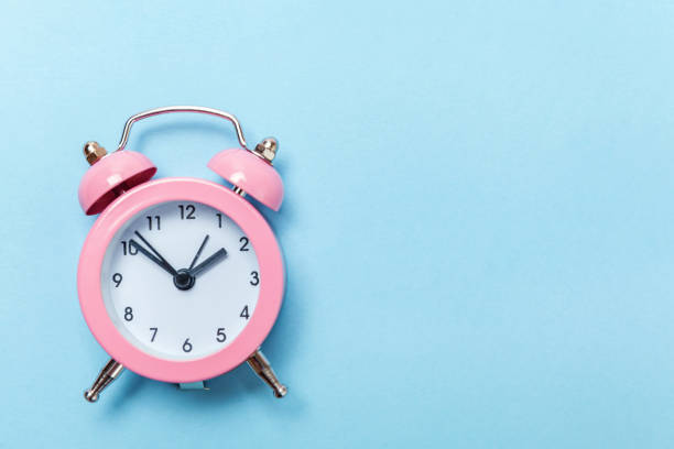 istock Vintage alarm clock Isolated on blue pastel background 1134635225