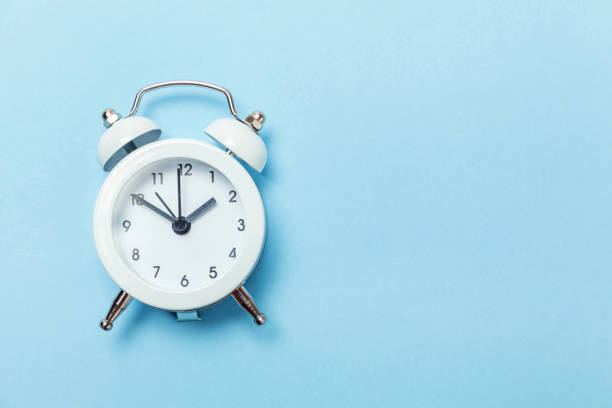 istock Vintage alarm clock Isolated on blue pastel background 1134635292