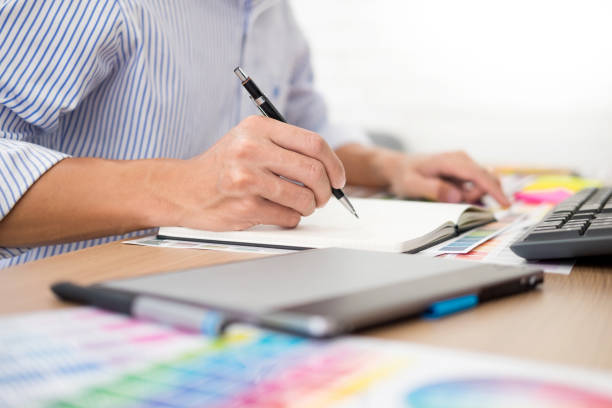 istock Midsection Of Businessman Writing In Diary At Desk 1134635350