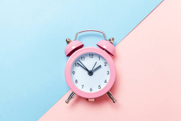 istock Vintage alarm clock Isolated on blue and pink pastel background 1134635546