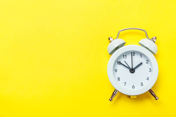 istock Vintage alarm clock Isolated on yellow background 1134636133
