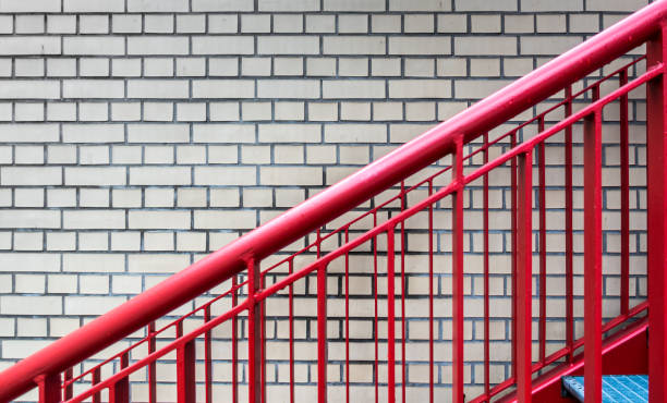 istock Close-Up Of Red Railing Against Brick Wall 1134636186