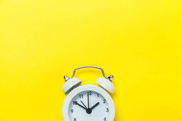 винтажный будильник изолирован на желтом фоне - clock face time alarm clock working стоковые фото и изображения