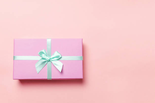istock Christmas New Year birthday valentine celebration present romantic concept. Pink gift box isolated on pink background 1134636344