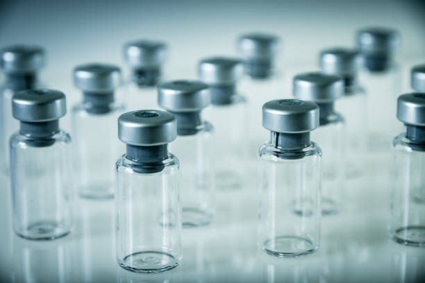 istock Vaccine glass bottles on grey background 1134638458