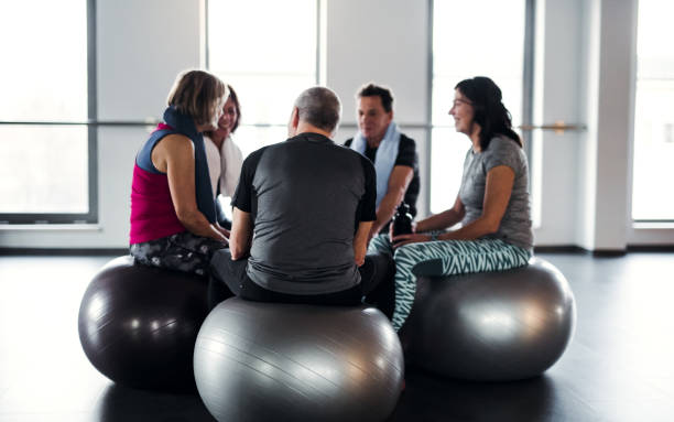 istock A group of seniors in gym resting after doing exercise on fit balls, talking. 1134638471