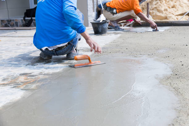 istock Midsection Of Men Leveling Wet Cement With Tool 1134643728