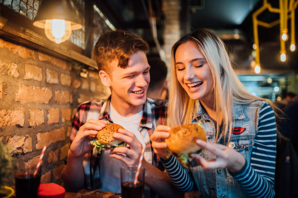 istock Happy couple eating hamburgers 1134647234