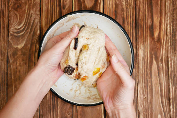 istock Housewife makes the dough kneading with dried fruit 1134650058
