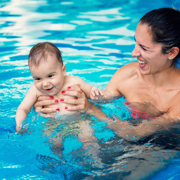 istock Happy Mother And Son Swimming In Pool 1134651299