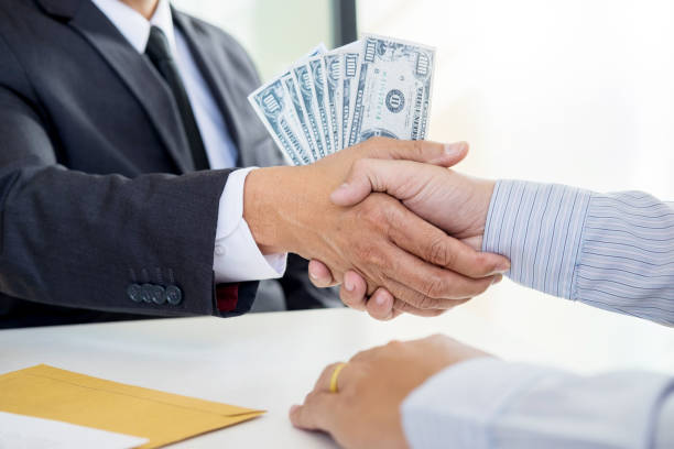 istock Cropped Image Of Businessman Bribing Entrepreneur While Shaking Hands At Office 1134652208