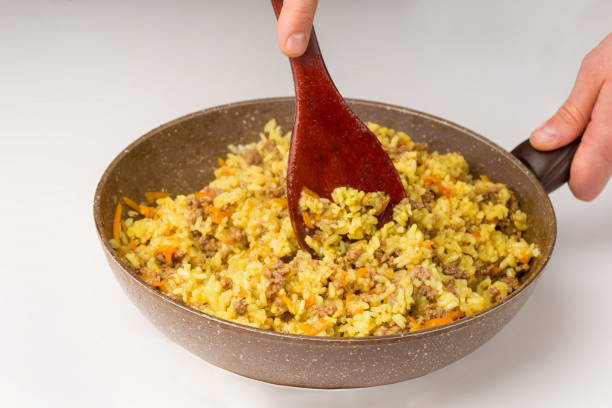 istock Frying pan full of yellow rice minced meat on white 1134654004