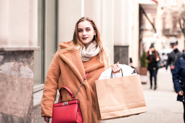 istock Beautiful young blonde outdoors holding packages after shopping 1134654074