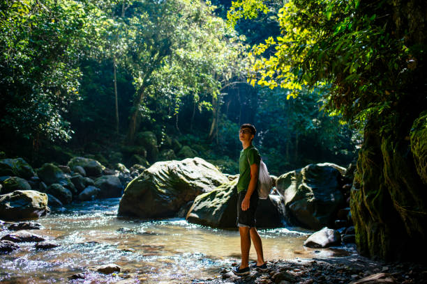 Young traveller is walking along a jungle stream in the amazon forest / Tarapoto/ north peru/ South America stock photo