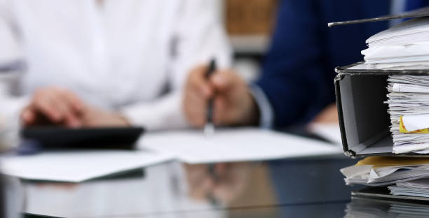 istock Binders with papers are waiting to be processed with bookkeeper. Internal Revenue Service inspector working place. View from above 1134655258