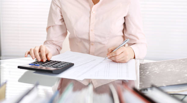 istock Unknown bookkeeper woman or financial inspector  making report, calculating or checking balance, close-up. Business portrait. Audit or tax concepts 1134655339