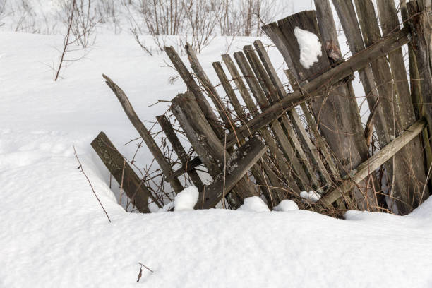 rotto vecchia recinzione di legno in un villaggio - winter finland agriculture barn foto e immagini stock