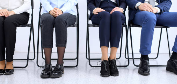 istock Group of business people sitting in office and waiting for job interview while using gadgets, close-up. Conference or training concepts 1134658838