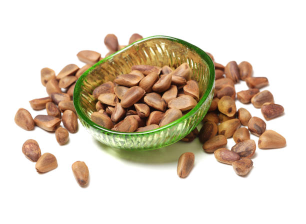 Pile of pine nuts on white background