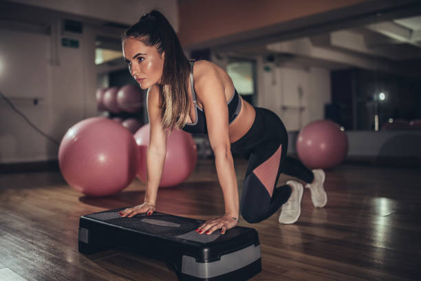 istock Young woman exercising in the gym 1134660478