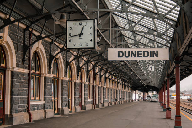 capture of empty platform at famous and historic railway station in Dunedin Dunedin, New Zealand - September 24th 2016: platform 1 at famous railway station in Dunedin (Otago) dunedin new zealand stock pictures, royalty-free photos & images