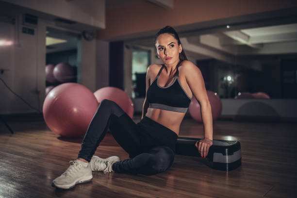 istock Young woman exercising in the gym 1134660509