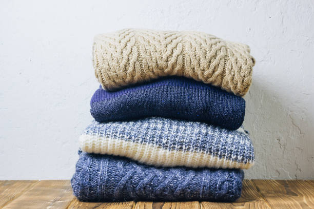 istock Knitted wool sweaters. Pile of knitted winter clothes 1134661437