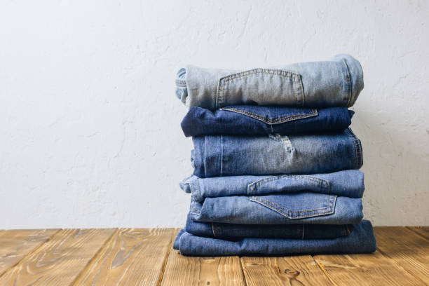 jeans denim cloth garment monochrome blue textile stacked on wooden table