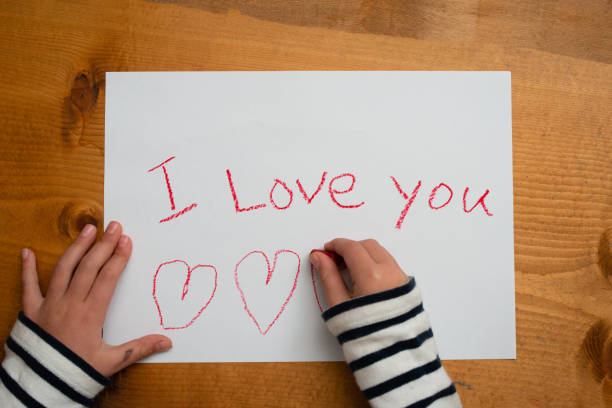 istock Child writes i love you on paper 1134663847