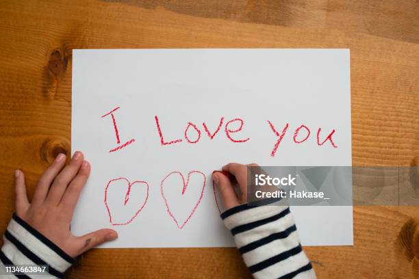 Child Writes I Love You On Paper Stock Photo - Download Image Now - Letter - Document, Child, Handwriting