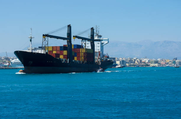 istock Container ship sailing from the Bay of Heraklion, accompanied by a pilot ship 1134665825