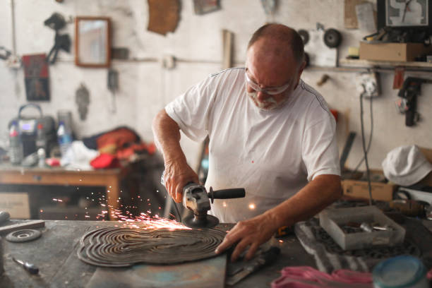 istock a Senior man creating sculptures in his art studio 1134667606