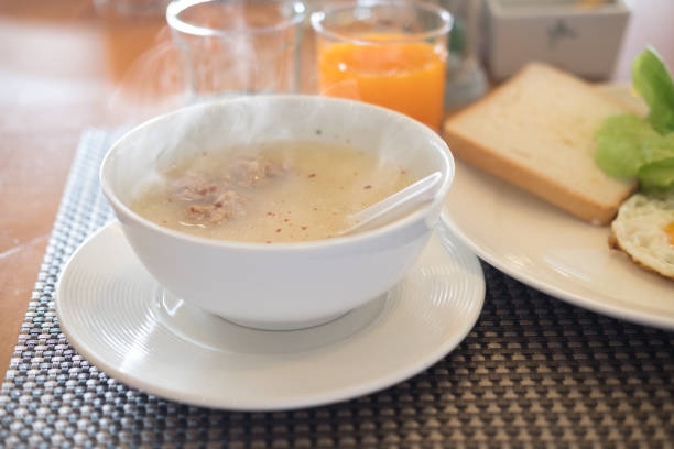 Close up mush or boiled rice in white bowl in hotel, morning breakfast