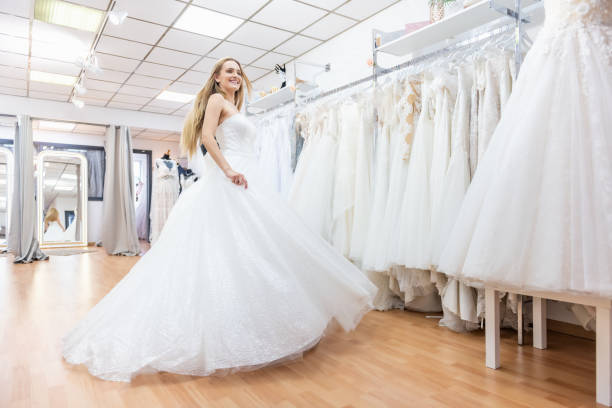 istock Happy bride dancing in bridal shop 1134669862