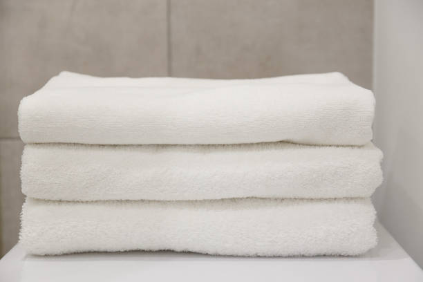 istock Stack of white clean towels on table in bathroom 1134669866