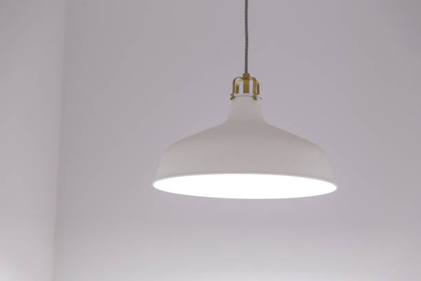 istock White lighting fixture with white wall background. 1134669870