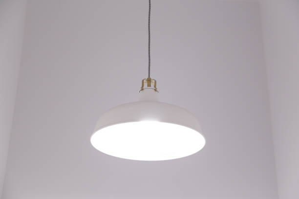 istock White lighting fixture with white wall background. 1134669871
