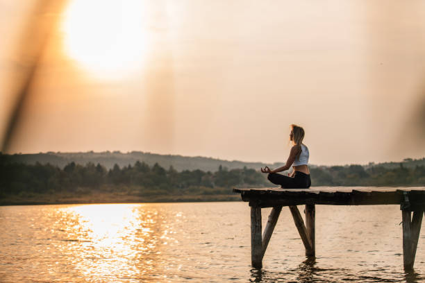 istock Young woman doing yoga meditation 1134670063