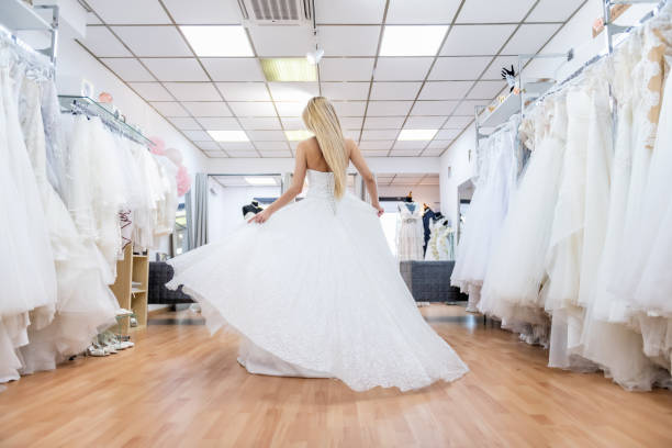 istock Blonde bride dancing in bridal shop 1134670108
