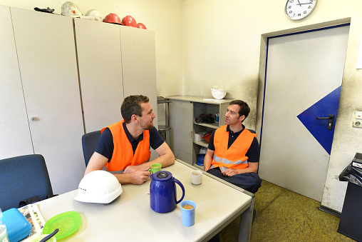 group of workers in an industrial company take a coffee break