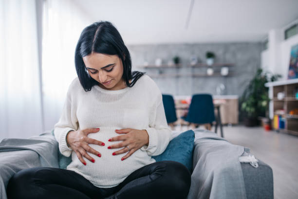 istock Pregnant woman holding her belly 1134671278